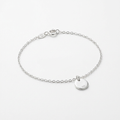 Sterling silver delicate charm bracelet on white background