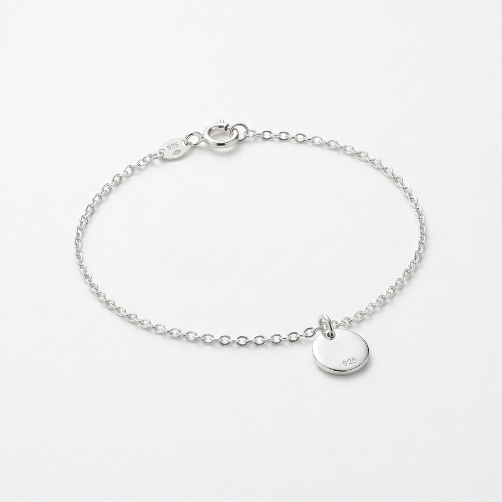 Sterling silver delicate charm bracelet on white background