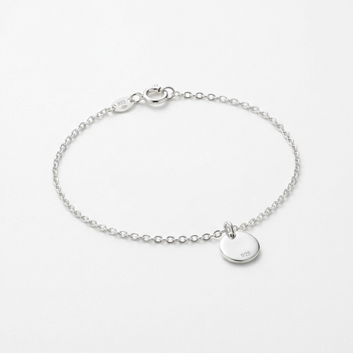 Sterling silver delicate charm bracelet on white background